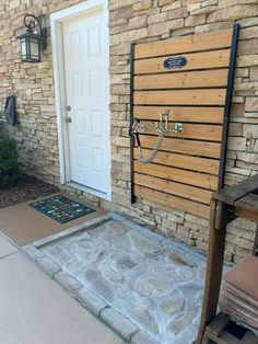 the front door to a house with a stone walkway