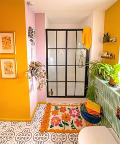 a bathroom with yellow walls and tiled floors