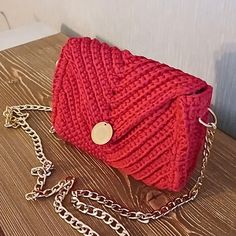 Handmade Red Crochet Bag - Gold Chain & Magnetic Flap This elegant handmade crochet bag will elevate your style! 👛  Crafted in a vibrant red, this bag stands out with its soft texture and intricate craftsmanship. It features a long gold chain strap, allowing you to wear it over the shoulder or crossbody.  The flap closes securely with a magnetic clasp, ensuring your belongings stay safe.  The interior is lined with satin for an added touch of luxury, protecting your items while maintaining the Trendy Red Crochet Bag, Handmade Red Crochet Crossbody Bag, Red Crochet Rectangular Shoulder Bag, Handmade Red Crochet Shoulder Bag, Handmade Crochet Bags, Red Crochet, Design Bag, Red Bag, Bag Stand