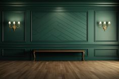 an empty room with green walls and wooden flooring is lit by two sconces