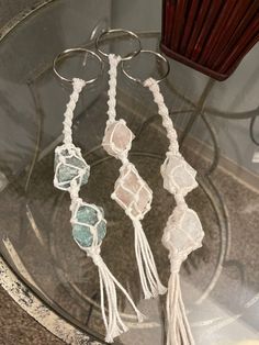 three tassels are hanging on a glass table