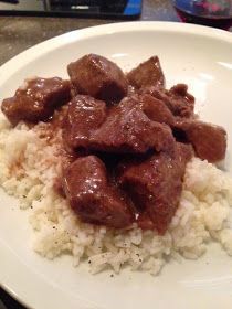 a white plate topped with meat and rice