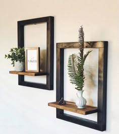 there are two wooden shelves with plants in them on the wall next to each other