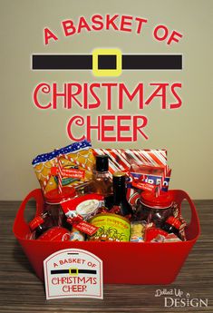 a basket of christmas cheer on a table with the words, a basket of christmas cheer