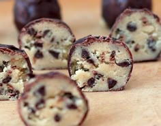 chocolate chip doughnuts cut in half on a cutting board