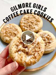 a person holding a cookie on top of a plate with the words glimmore girls coffee cake cookies