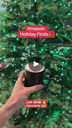 someone holding a coffee mug in front of a christmas tree with the words amazon holiday finds on it