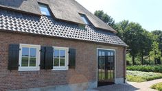 a brick house with black shutters and white windows