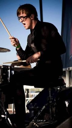 a young man playing drums on stage