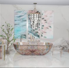 a bathroom with marble counter tops and art on the wall