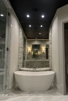 a bathroom with a large bathtub next to a walk in shower