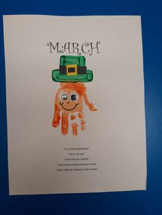 a child's handprint with the name march on it and a green hat