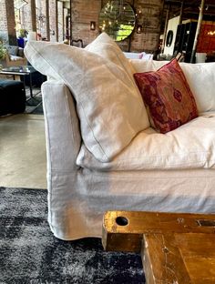 a white couch sitting on top of a wooden table