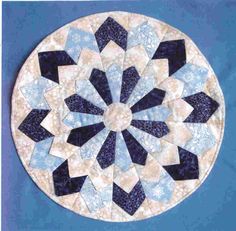 a blue and white circular quilt on a blue background