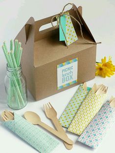 a box filled with wooden utensils and paper napkins