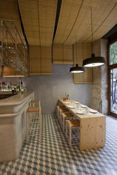 a kitchen with checkered flooring and an island in front of the counter top