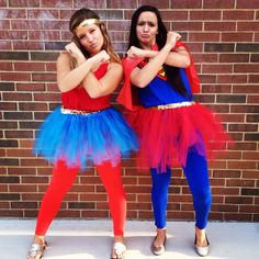 two girls dressed in costumes standing next to each other with their hands on their hips