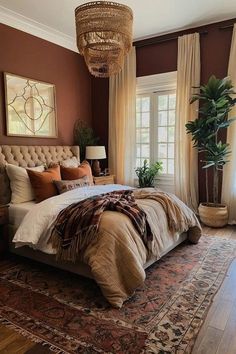 a bedroom with a large bed and chandelier hanging from the ceiling