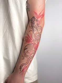 a man with a dragon tattoo on his arm