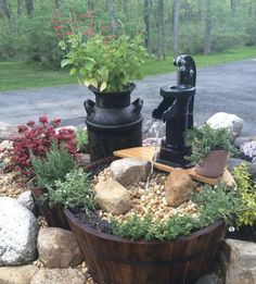 a wooden barrel filled with rocks and plants