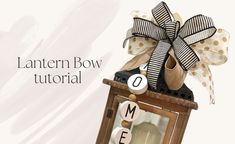 a lanterner bow is on top of a wooden box with the word home spelled out