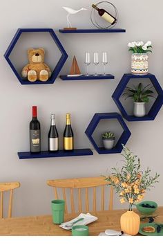 three shelves with wine bottles, glasses and other items on them in the shape of hexagons