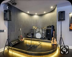 a room with some guitars and other musical equipment on the floor in front of it