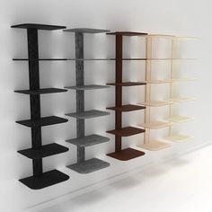 three shelving units are lined up against the wall, one is black and one is white