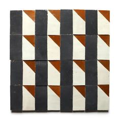 a black and white tile with brown diagonals on the bottom, in different colors