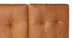 an upholstered brown leather headboard with square stitching on the back and sides