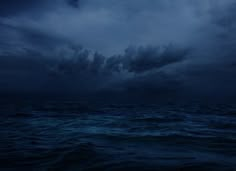 dark clouds over the ocean at night time