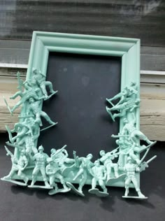 a group of toy figurines sitting in front of a blackboard with a frame