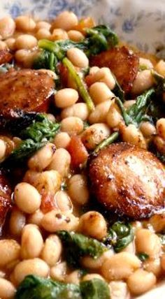 a white bowl filled with beans and spinach