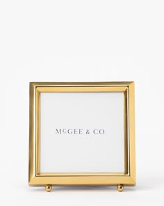 a gold frame with the word'megel & co'printed on it in black ink