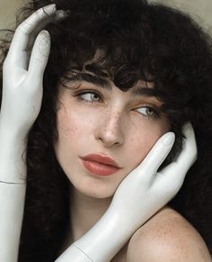 a close up of a person wearing white gloves