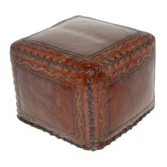 a brown leather box with intricate designs on it