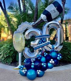 the balloon sculpture is decorated with blue and silver balloons, which spell out the number 30