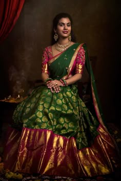 a woman in a green and gold sari