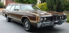 an old station wagon is parked on the street