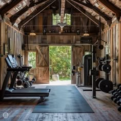 an open gym with lots of machines and exercise mats