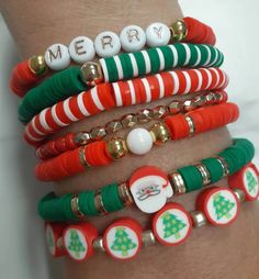 a stack of bracelets with christmas decorations on them and the words merry written in white letters