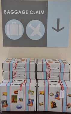 several boxes stacked on top of each other in front of a baggage claim sign