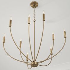 a brass chandelier with six lights hanging from it's center and four arms