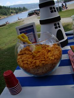 a bowl filled with cereal sitting on top of a blue and white striped table cloth