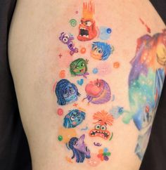 the back of a woman's thigh with cartoon characters on it and bubbles around her