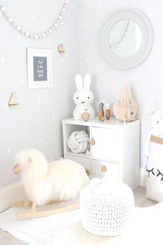 a white room with toys and decor on the walls