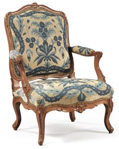 an old fashioned chair with blue and white fabric on the back, sitting in front of a white background