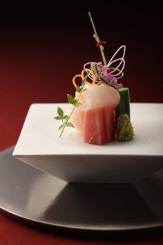 a white plate topped with sushi and garnish