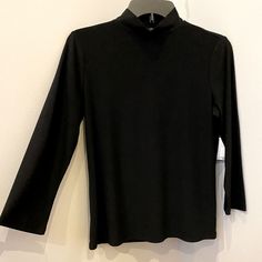 Brand New W/Tag 96% Polyester Turtle Neck Classic Black High Neck Top, Black High Neck Classic Top, Classic High Neck Black Top, Classic Black Turtleneck Top, Black Long Sleeve Mock Neck Top For Layering, Black Mock Neck Top With Long Sleeves For Layering, Spring Mock Neck Top For Workwear, Black Stretch Mock Neck Top For Layering, Fitted Black Turtleneck Top