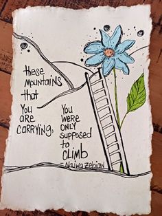 a piece of paper with an image of a ladder and a blue flower on it